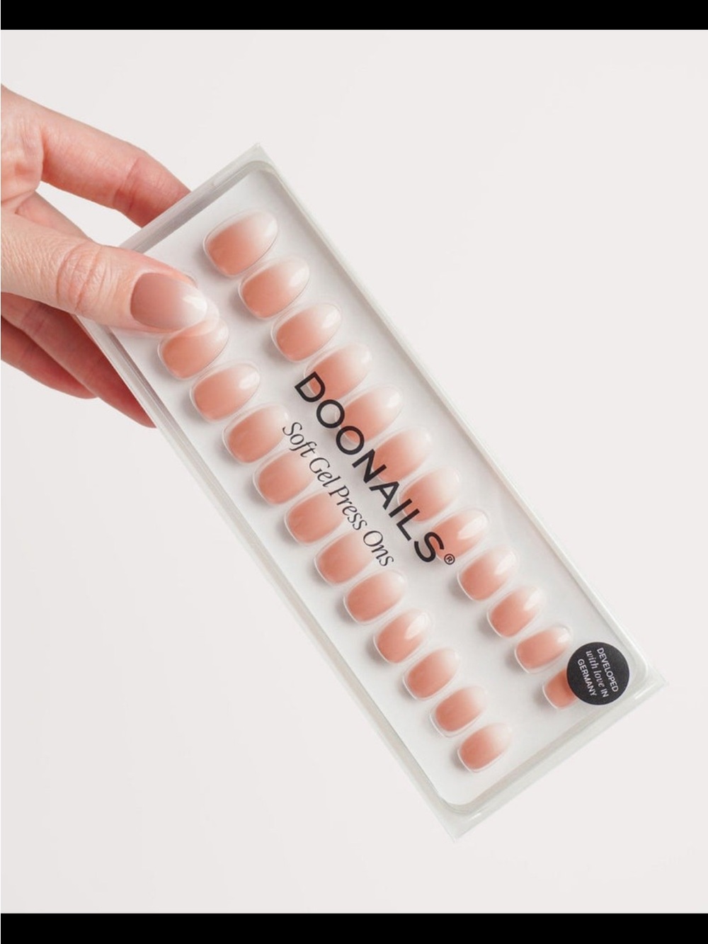 Doonails Soft Gel Press-On Nails in shade “Baby Boomer,” short round.